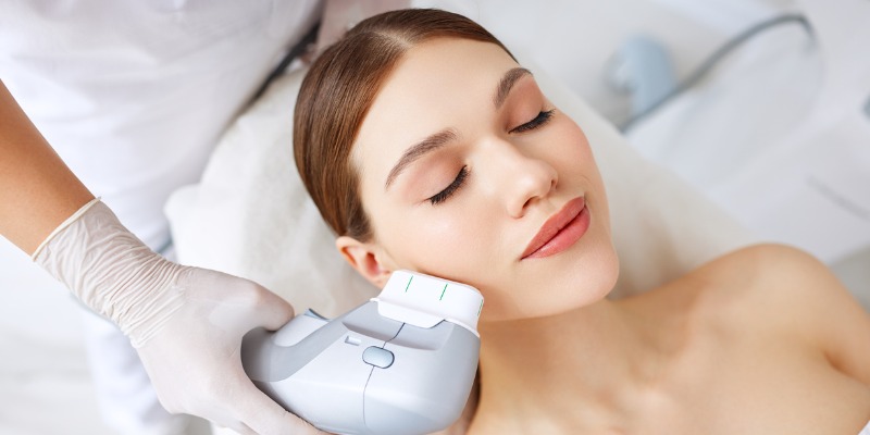 Woman getting facial lifting therapy in beauty salon